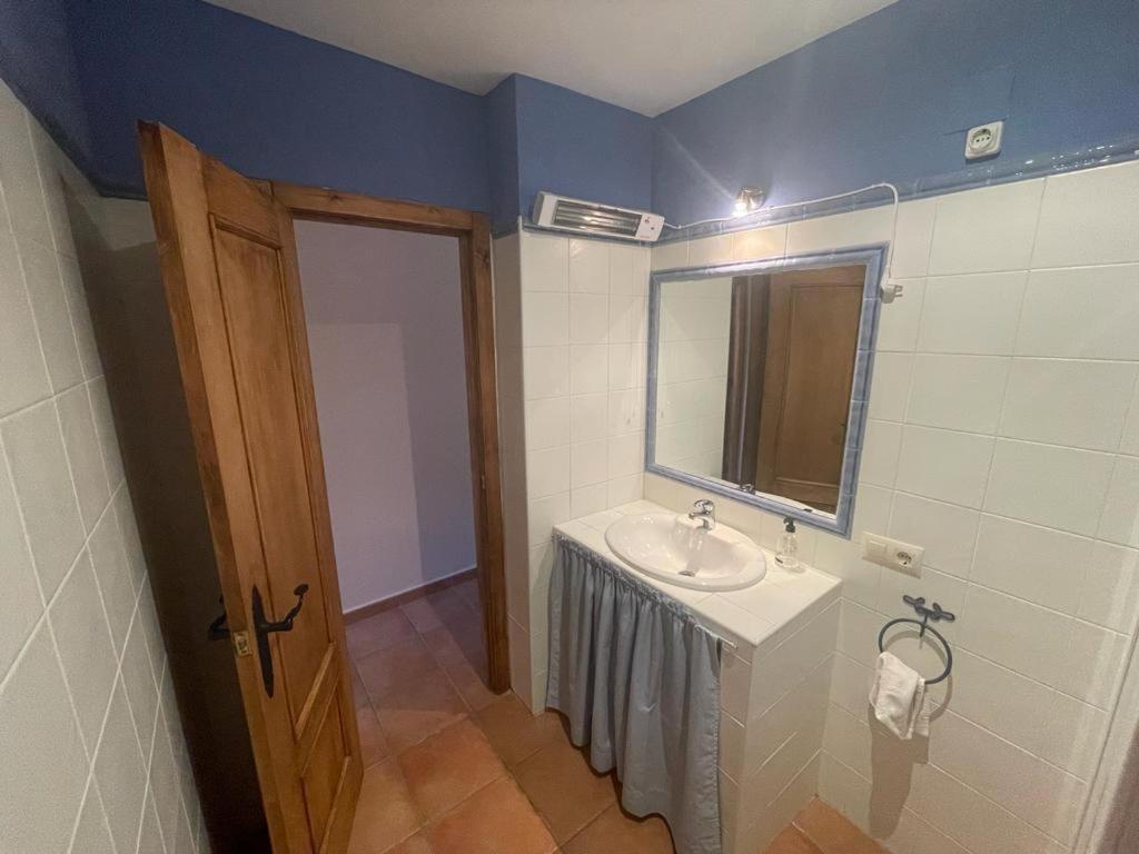 a bathroom with a sink and a mirror at El Quejigo in Molinicos