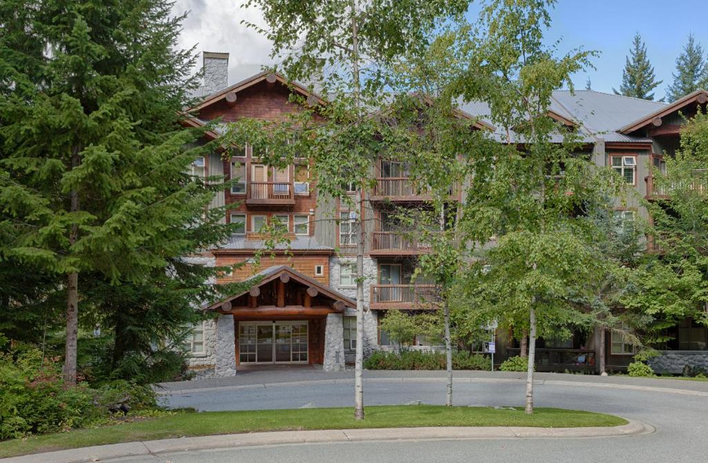 a large building with trees in front of it at Lost Lake Lodge by Whistler Premier in Whistler