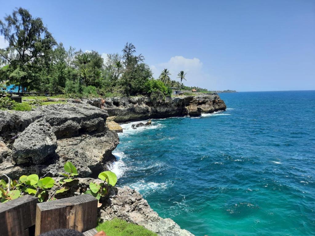 a view of the ocean from a rocky beach at Casa boca chica in Boca Chica