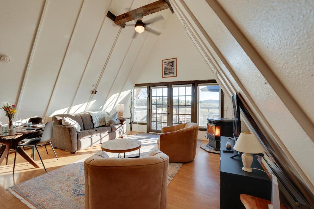 a living room with a couch and a table at Jefferson A-Frame Cabin with Rocky Mountain Views in Bordenville