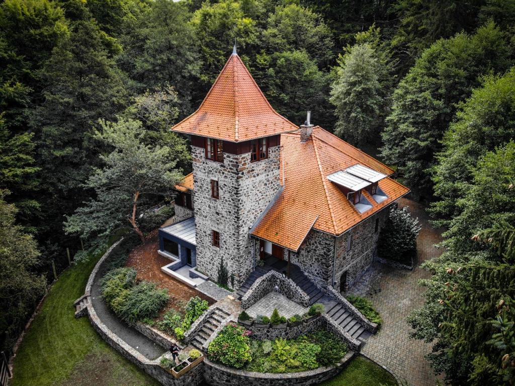an aerial view of a castle in the forest at Templomvölgy Resort Mátrakeresztes in Matrakeresztes