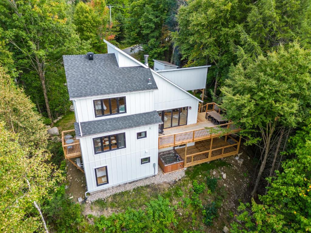 an overhead view of a white house in the woods at Ski in Tremblant and Mont Blanc, Views, Spa and Pool table in Saint-Faustin