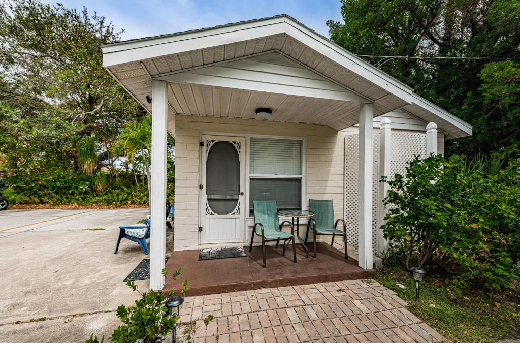 a shed with a table and chairs on a patio at Sunset Beach Bungalow 1 in St Pete Beach