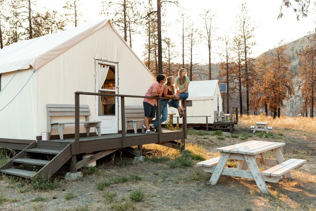 a group of people standing outside of a tent at Kumsheen Rafting Resort in Lytton