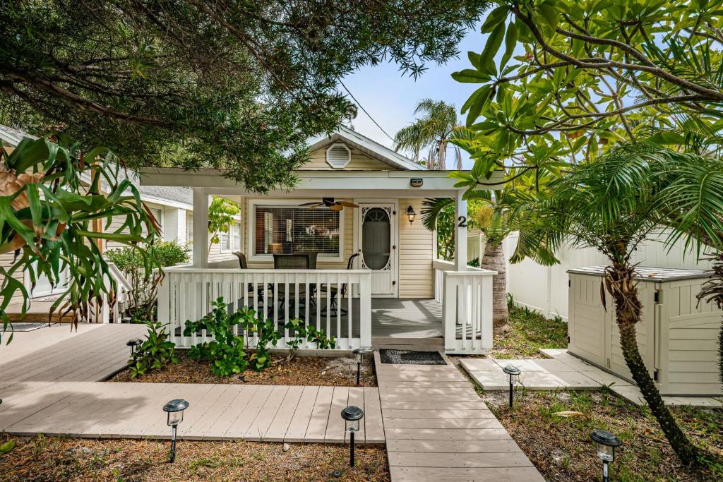a white house with a white fence at Sunset Beach Bungalow 2 in St Pete Beach