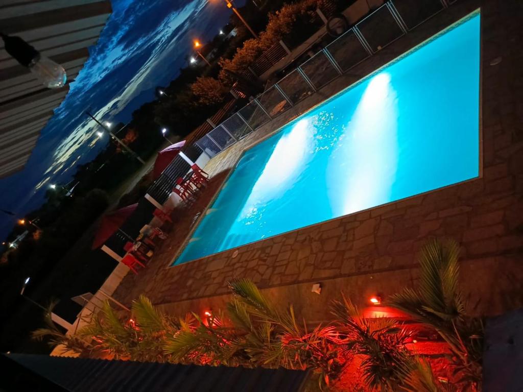 a large swimming pool with a large blue screen at Chiriguare parrilla in Villavicencio