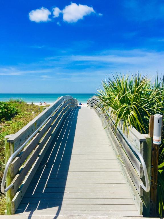 a boardwalk leading to the beach on a clear day at Sunset Beach Bungalow 3 in St. Pete Beach