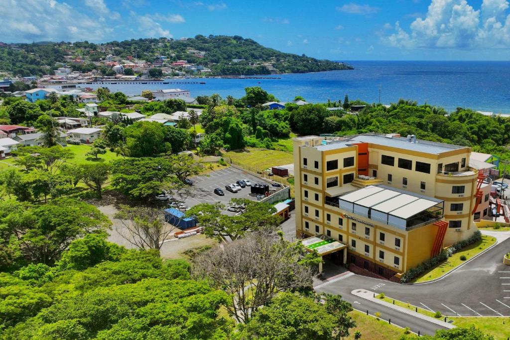 an aerial view of a building with the ocean in the background at Comfort Inn & Suites Tobago in Tobago Island
