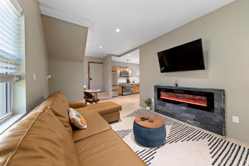 a living room with a couch and a fireplace at Modern Home &Cozy in Lake Placid