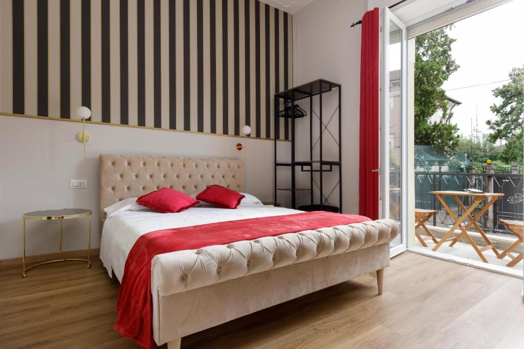 a bedroom with a large bed with red pillows at Domus 44 Rooms in Verona