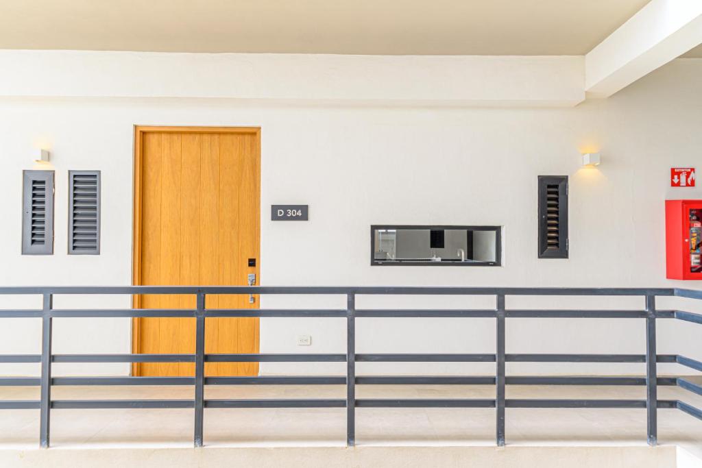 an empty room with a door and a railing at Lumina at Cardinal San José del Cabo in San José del Cabo