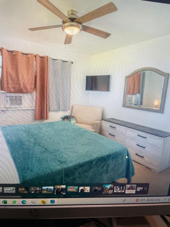Schlafzimmer mit einem Bett und einem Deckenventilator in der Unterkunft John’s Place in Grand Turk