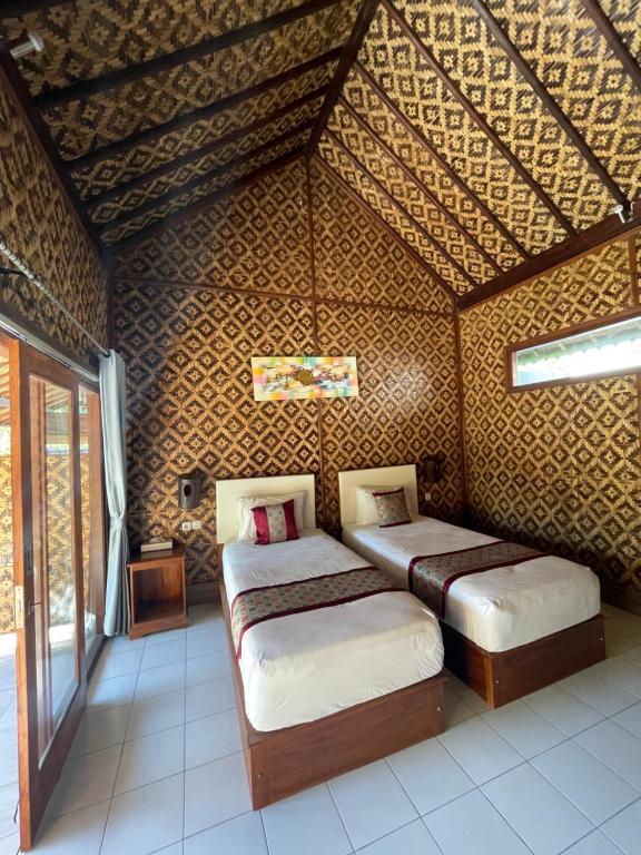 Postel nebo postele na pokoji v ubytování Tebu menjangan homestay