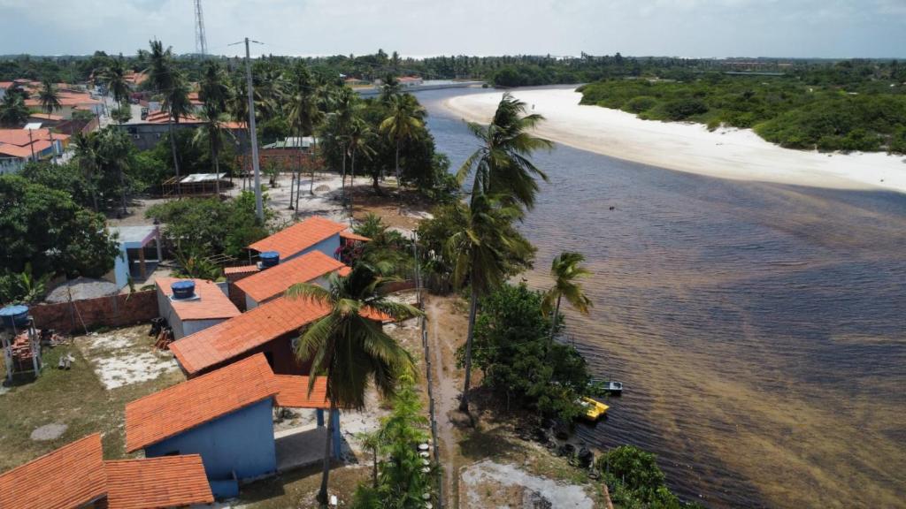 een luchtzicht op een strand met huizen en palmbomen bij Chalé recanto do sol in Santo Amaro