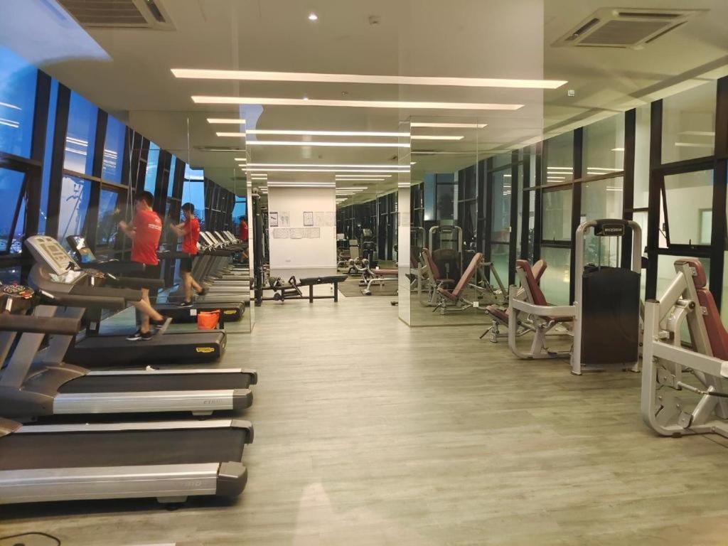 a gym with people exercising on treadmills and machines at Mid Vally Southkey JB, 2BR, WIFI, 7 mins to CIQ in Johor Bahru