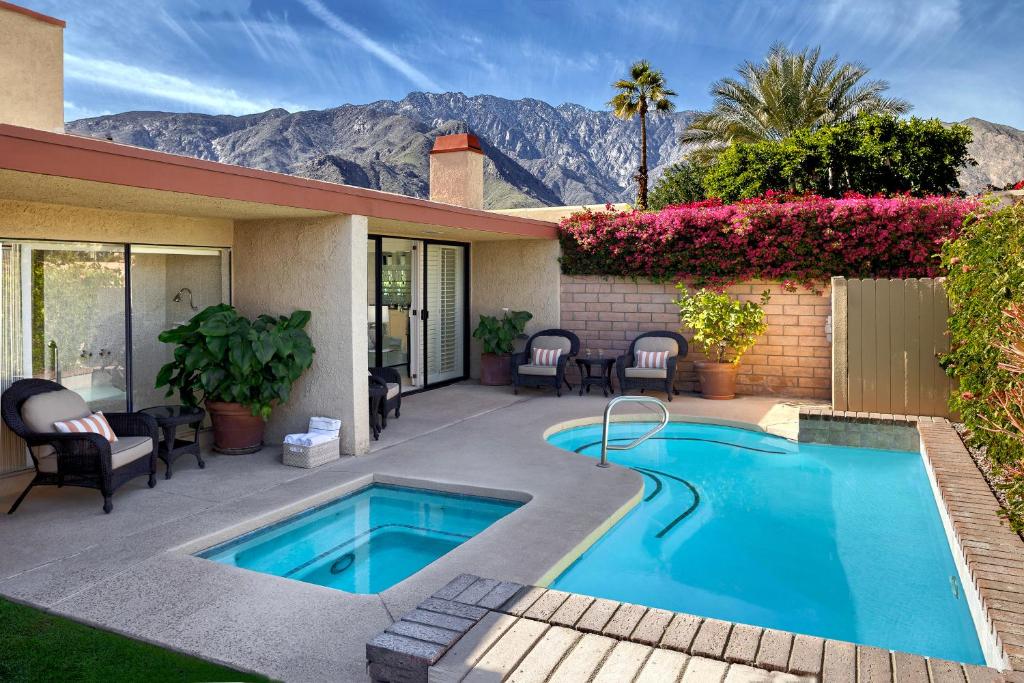 a swimming pool in front of a house at Sundance Villas by Private Villa Management in Palm Springs