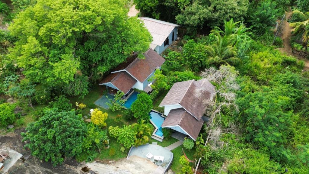 an overhead view of a house with trees at Hidden Lake Cottages Sigiriya in Sigiriya