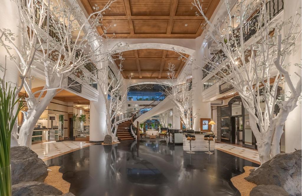 a lobby with trees in the middle of a building at Vivere Hotel and Resorts in Manila