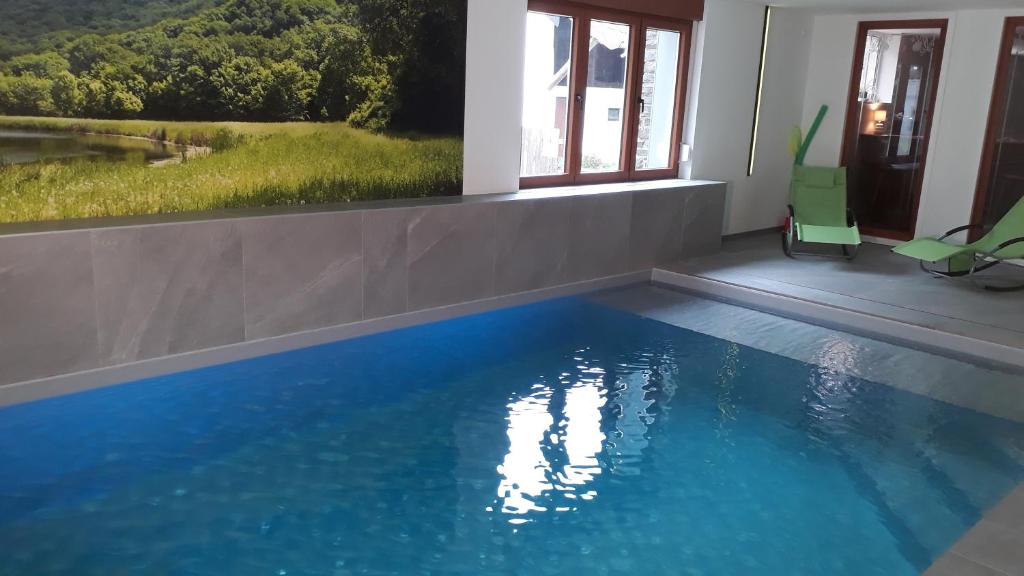 a swimming pool with blue water in a house at Villa Franzen in Derenbach
