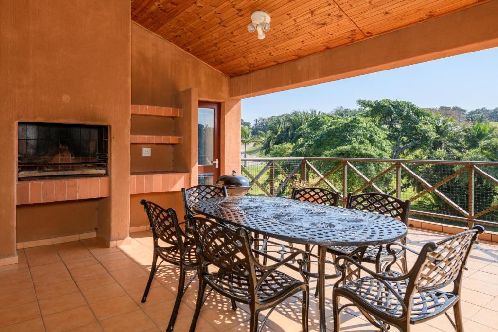 a patio with a table and chairs on a balcony at San Lameer Villa 10312 - 3 Bedroom Standard - 6 pax - San Lameer Rental Agency in Southbroom