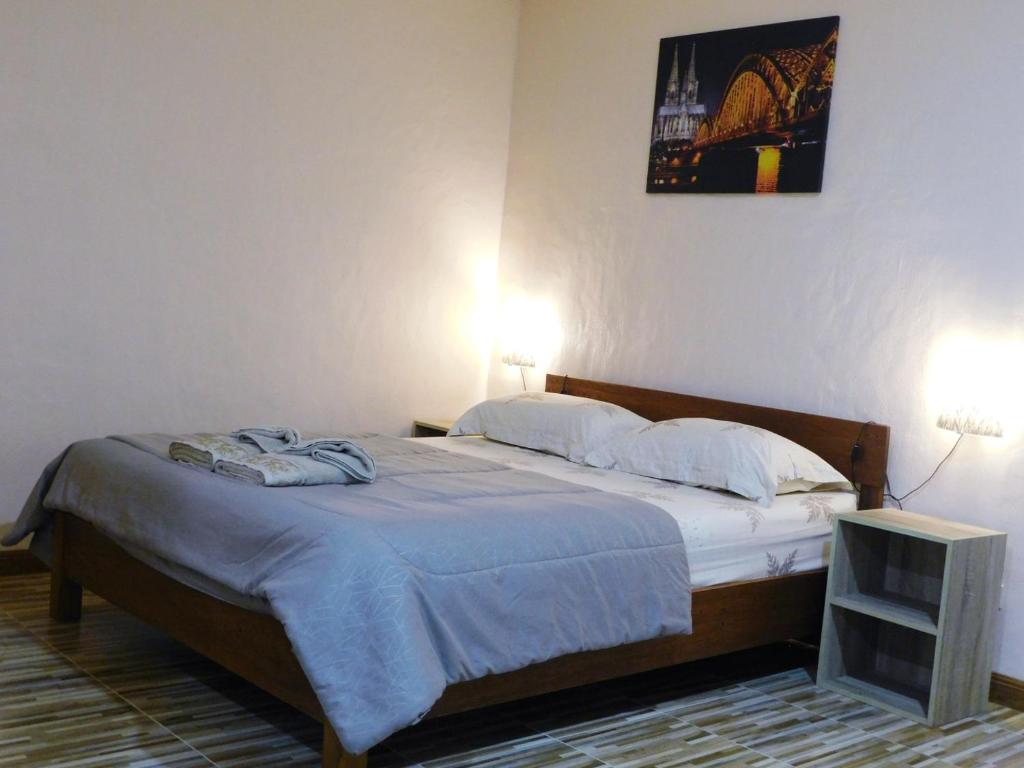 a bed in a bedroom with two lights on at Swiss Bonihouse Koh Yao Yai in Ban Phlu Nai