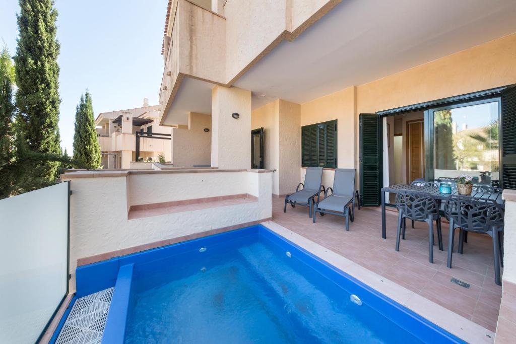 a villa with a swimming pool and a dining area at El Oasis Malasia 16 Bajo A in Fuente Alamo