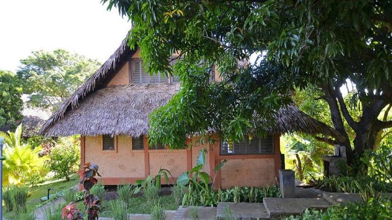 a small house with a thatched roof at Fleurdesiles in Nosy Be