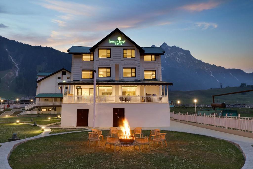 a hotel with a fire pit in front of a building at Lemon Tree Hotel, Sonamarg in Sonāmarg