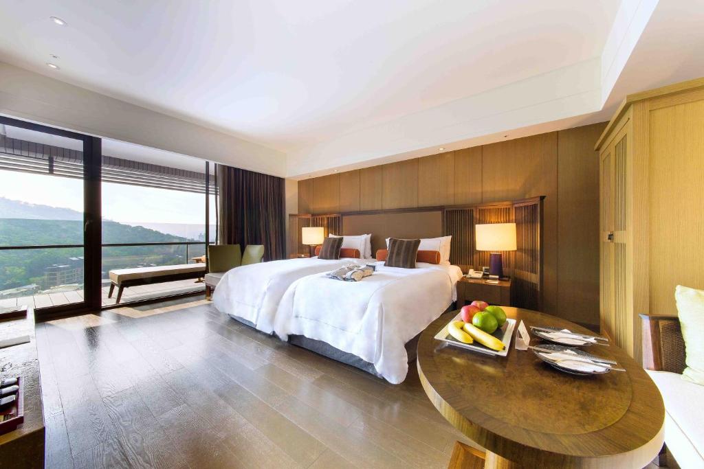 Postel nebo postele na pokoji v ubytování Grand View Resort Beitou