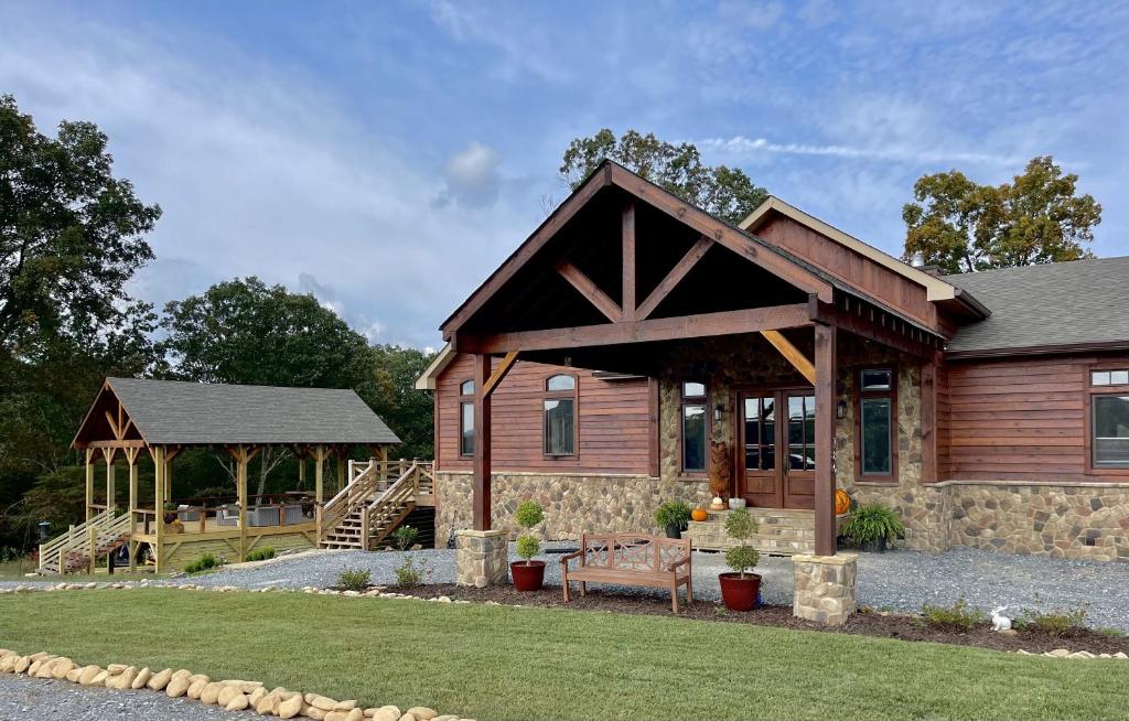a log cabin with a porch and a gazebo at The Dogwood Inn in Blue Ridge