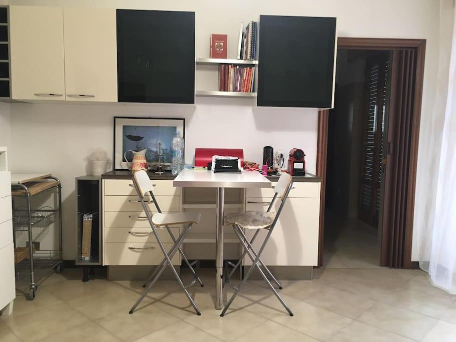 a kitchen with a table with two chairs and a desk at Vacation home Controra, Ginosa (TA) in Ginosa