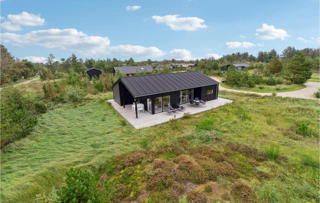an overhead view of a black house in a field at Cozy Home In Fjerritslev With Kitchen in Slettestrand