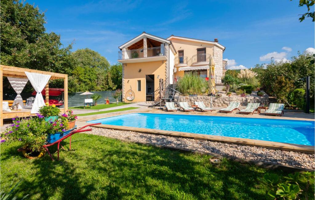 a villa with a swimming pool and a house at Stunning Home In Vinjani Donji With 5 Bedrooms, Wifi And Outdoor Swimming Pool in Majići