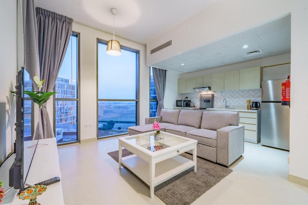 a living room with a couch and a table at Dar Alsalam - Modern Apartment With Stunning Views in Dania 3 in Dubai