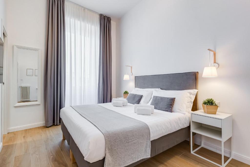 a bedroom with a large bed and a window at Colonna Luxury Apartment in Rome