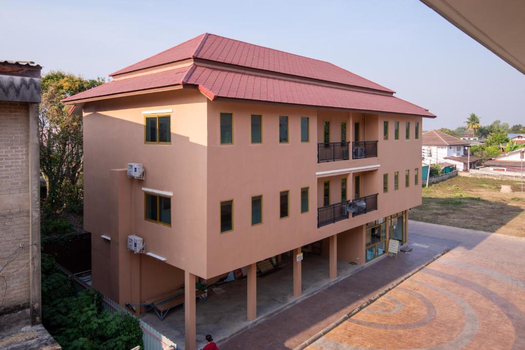 une vue de tête d'un bâtiment avec un toit rouge dans l'établissement โรงแรมเชียงคำรักคุณ, à Chiang Kham