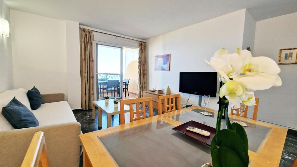 a living room with a couch and a table at AA Guest - Don Juan Eco Front Sea Views Apartment in Fuengirola