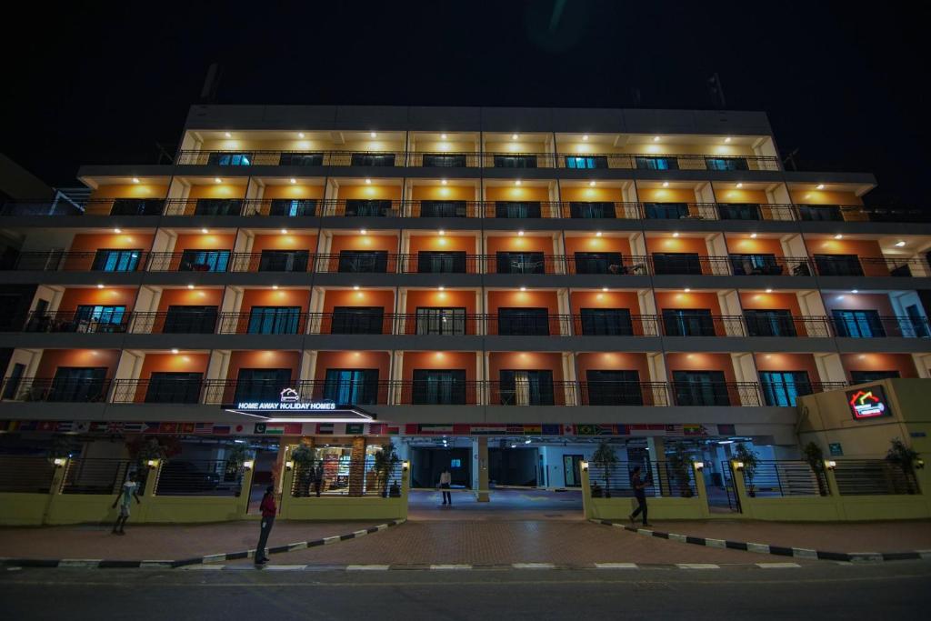 a large building with lights on it at night at Home Away Holiday Homes in Dubai