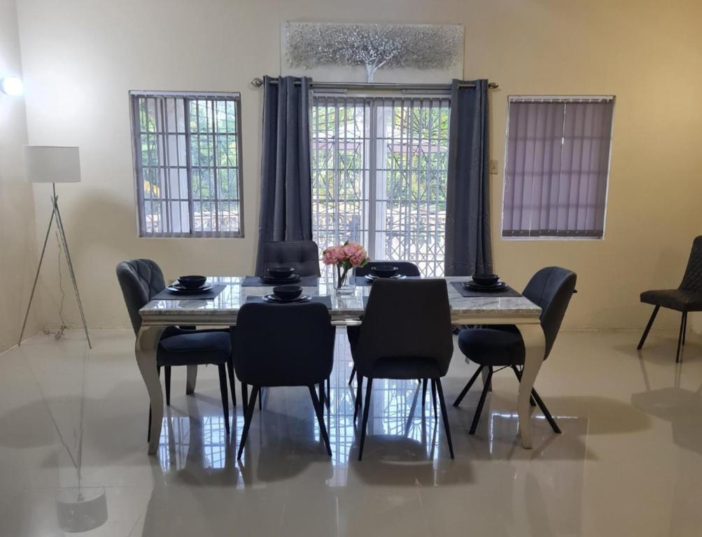a dining room with a table and chairs at Tropical Paradise Retreat in St Ann's in Priory