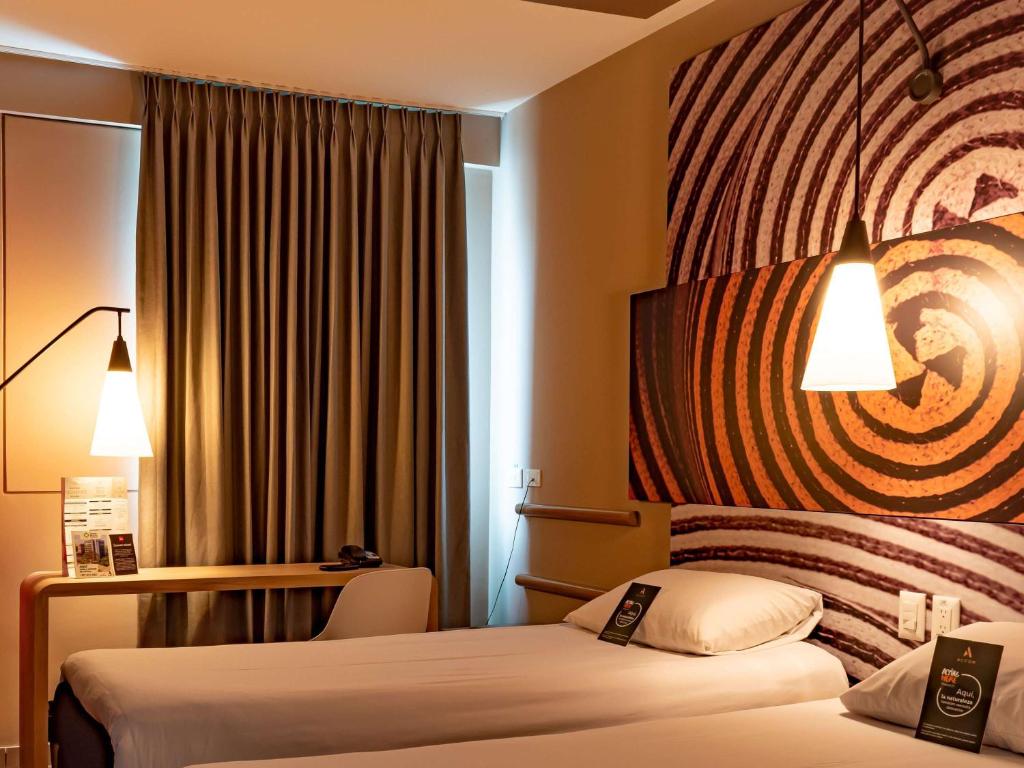 Postel nebo postele na pokoji v ubytování ibis Apartado