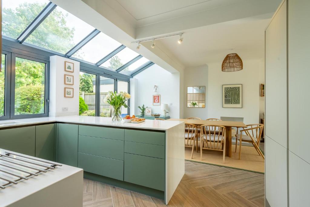 a kitchen with green cabinets and a dining room at The Birdie in York