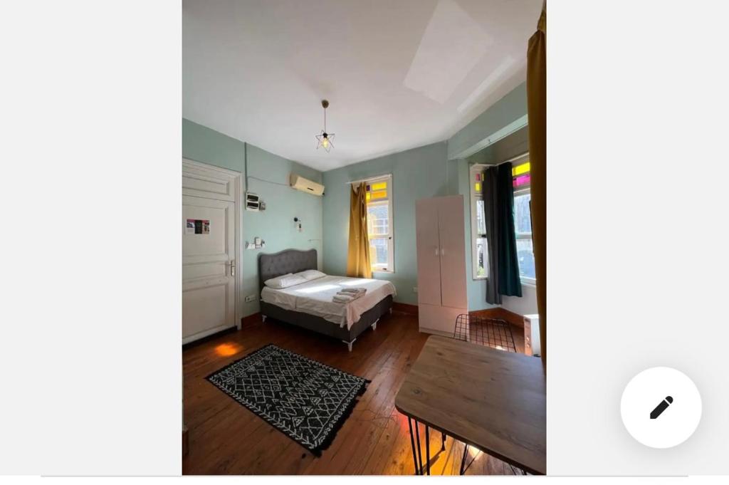 a bedroom with a bed and a table in a room at Cinar Apart in Istanbul