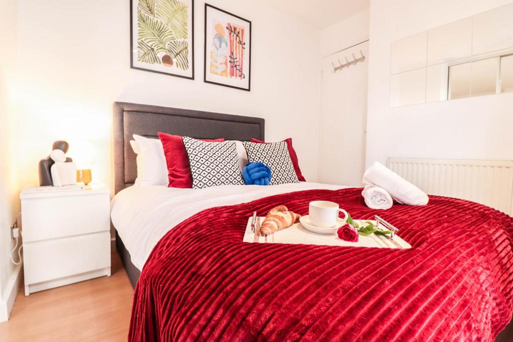 a bedroom with a bed with a tray of food on it at Steps to Oxford Street-Central 1BR Flat Sleeps 4 in London
