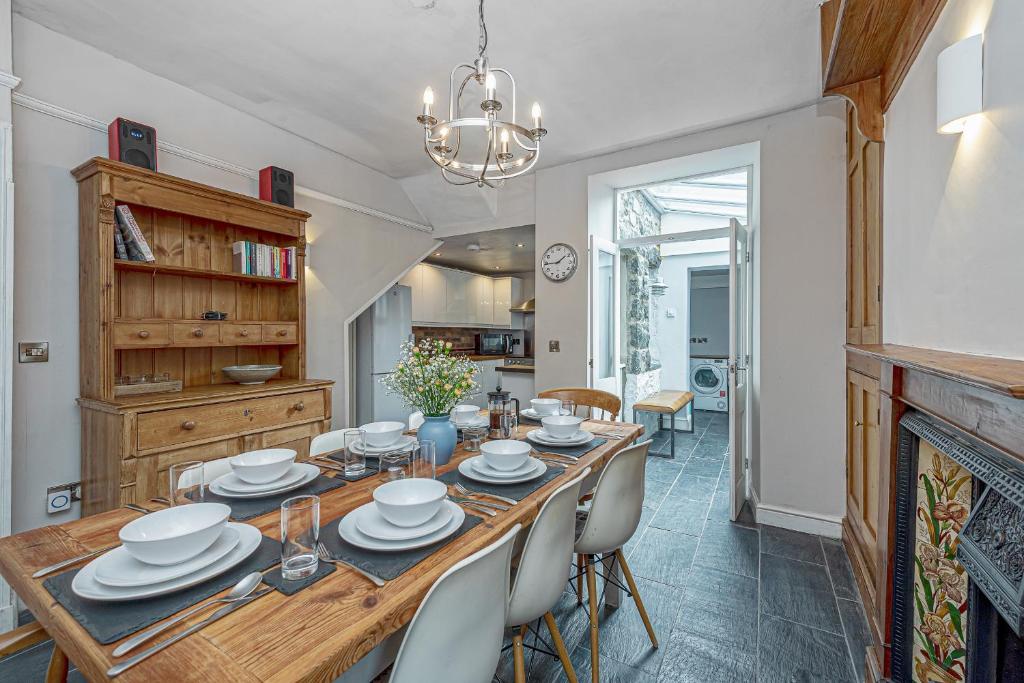 a dining room with a wooden table and chairs at Character Townhouse in Town Centre & Superb Views in Dolgellau