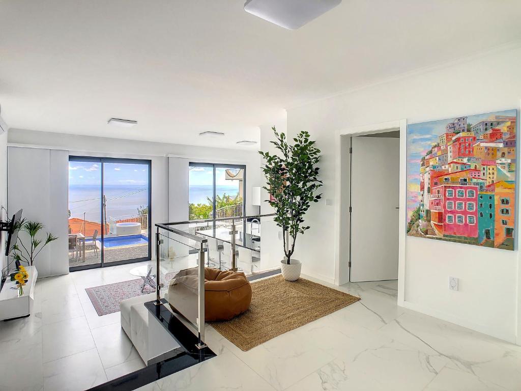 a living room with a staircase and a painting on the wall at Casa das Flores by LovelyStay in Calheta