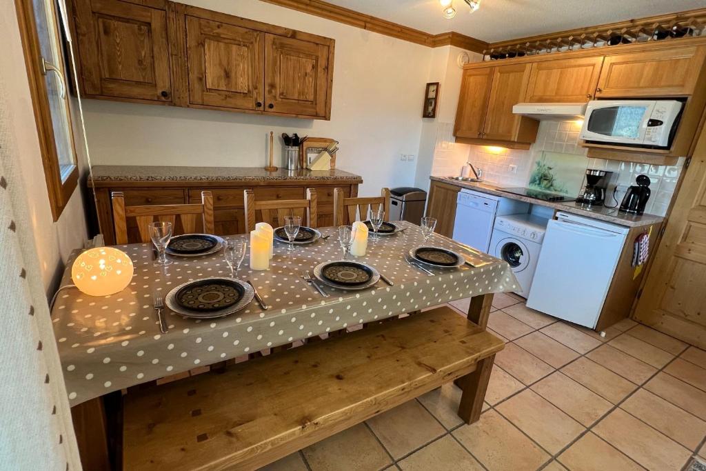 a kitchen with a table with a table cloth on it at Les Granges 13 6-8 person in Aime-La Plagne