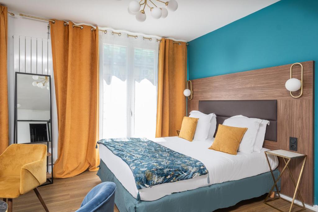 a hotel room with a bed and a window at The Originals Boutique, Hôtel Le Marignan,Le Havre Centre Gare in Le Havre