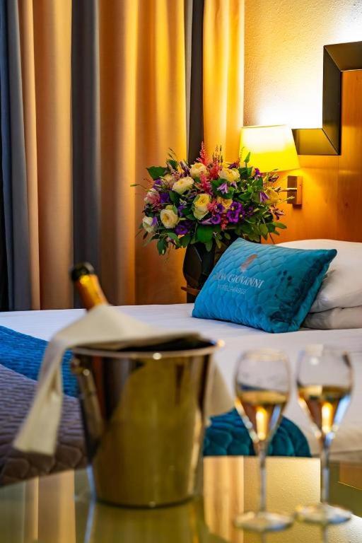 a hotel room with a table with two glasses of wine at Don Giovanni Hotel Prague - Great Hotels of The World in Prague