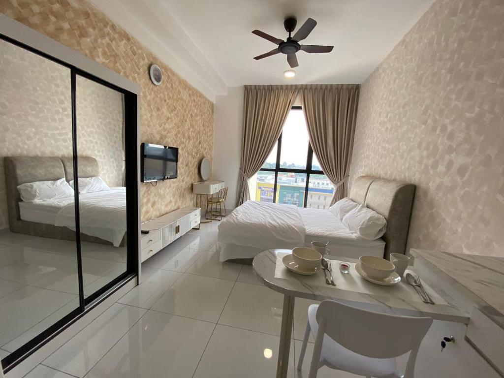 a bedroom with a bed and a table and a tv at Sky Trees Nflix Make Up Table with Pool & Facilities in Johor Bahru