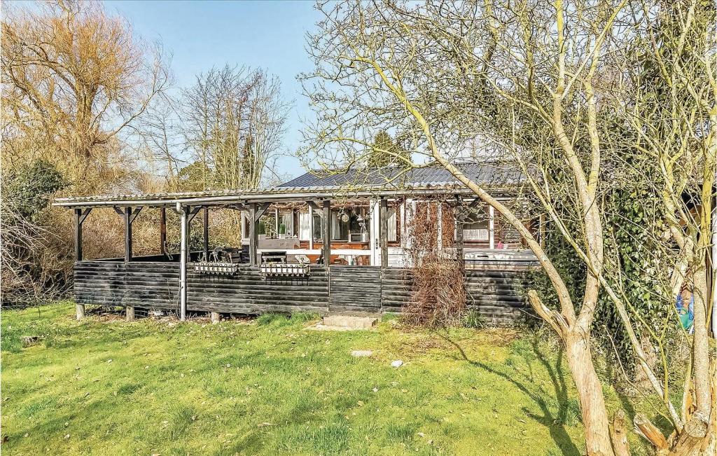 an old house is sitting in a field at Nice Home In Sydals With Wifi in Østerby